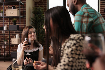 Side view of young woman using mobile phone