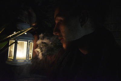 Close-up of young man smoking at home