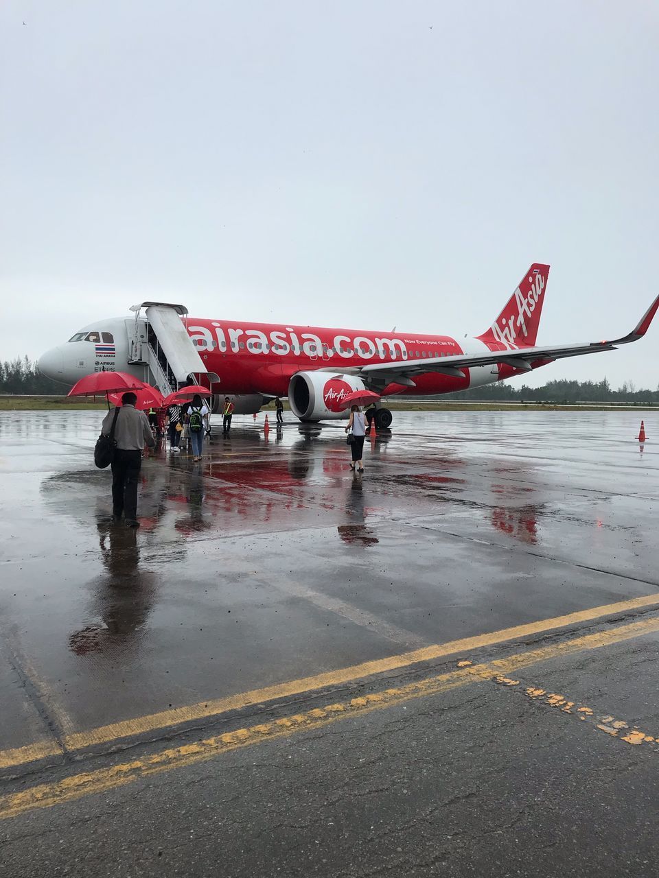 AIRPLANE ON WET ROAD AGAINST SKY