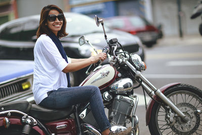 Side view of woman riding motorcycle