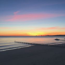 Scenic view of beach against sky during sunset