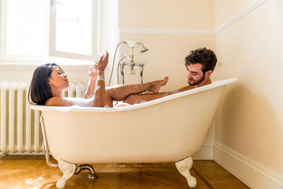 Side view of young couple in bathroom