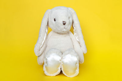 Close-up of stuffed toy against yellow background