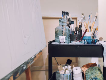 Close-up of various paintbrushes against wall