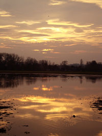 Scenic view of lake at sunset