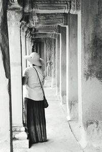 Rear view of woman walking in building