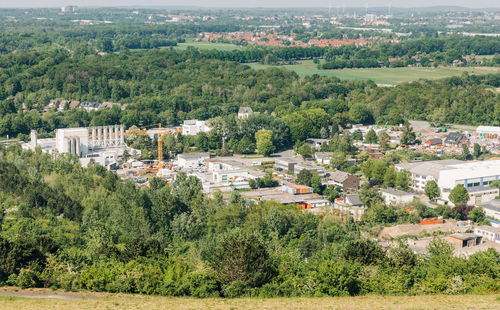 High angle view of trees and buildings in city