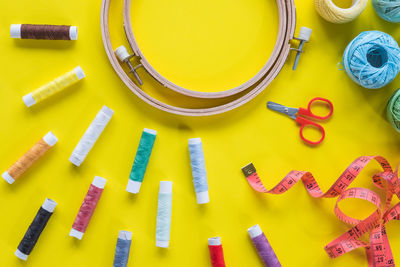 High angle view of multi colored sewing items on table