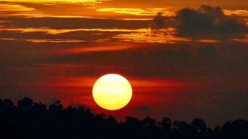 Scenic view of silhouette trees against romantic sky at sunset