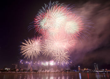 Low angle view of firework display in sky at night