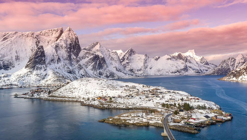 Scenic view of snowcapped mountains by lake against sky