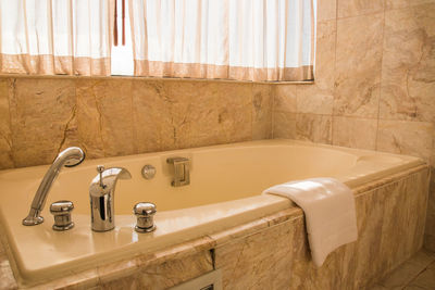 Close-up of faucet in bathroom at home