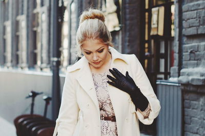 Young woman looking away in city