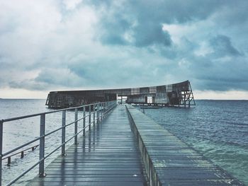 Pier on sea against sky