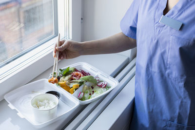 Nurse eating asian take-out food