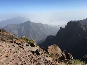 Scenic view of mountains against blue sky