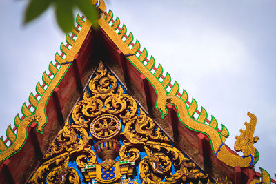 Low angle view of sculptures on building against sky