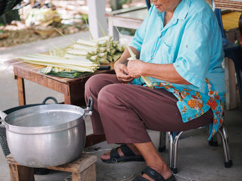 Low section of woman sitting on chair