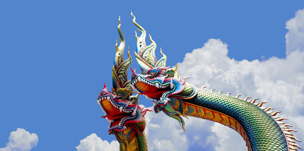 Low angle view of sculpture against blue sky