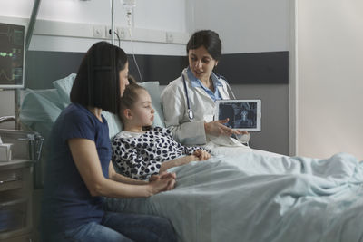 Female doctor examining patient in clinic