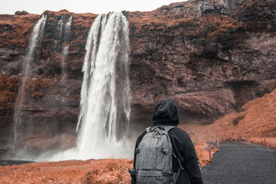 Rear view of waterfall against rock formation