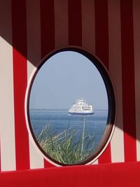 Panoramic view of sea seen through window