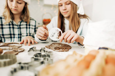 Close-up stencils for drawing cookies or gingerbread for christmas or new year in the hands of girls