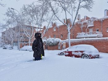 Man on snow covered tree during winter