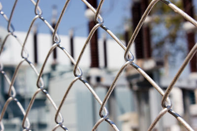 Close-up of chainlink fence against sky