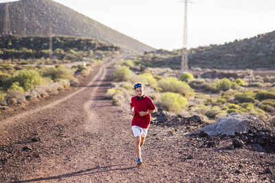 Full length of teenage boy running on land