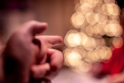 Close-up of hand holding illuminated lights