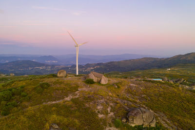 Beautiful stone penedo house drone aerial view in fafe with wind turbine, portugal