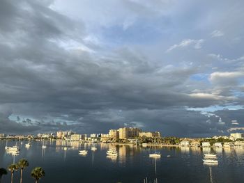 Buildings by sea against sky