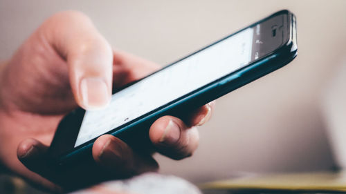 Close-up of man using mobile phone