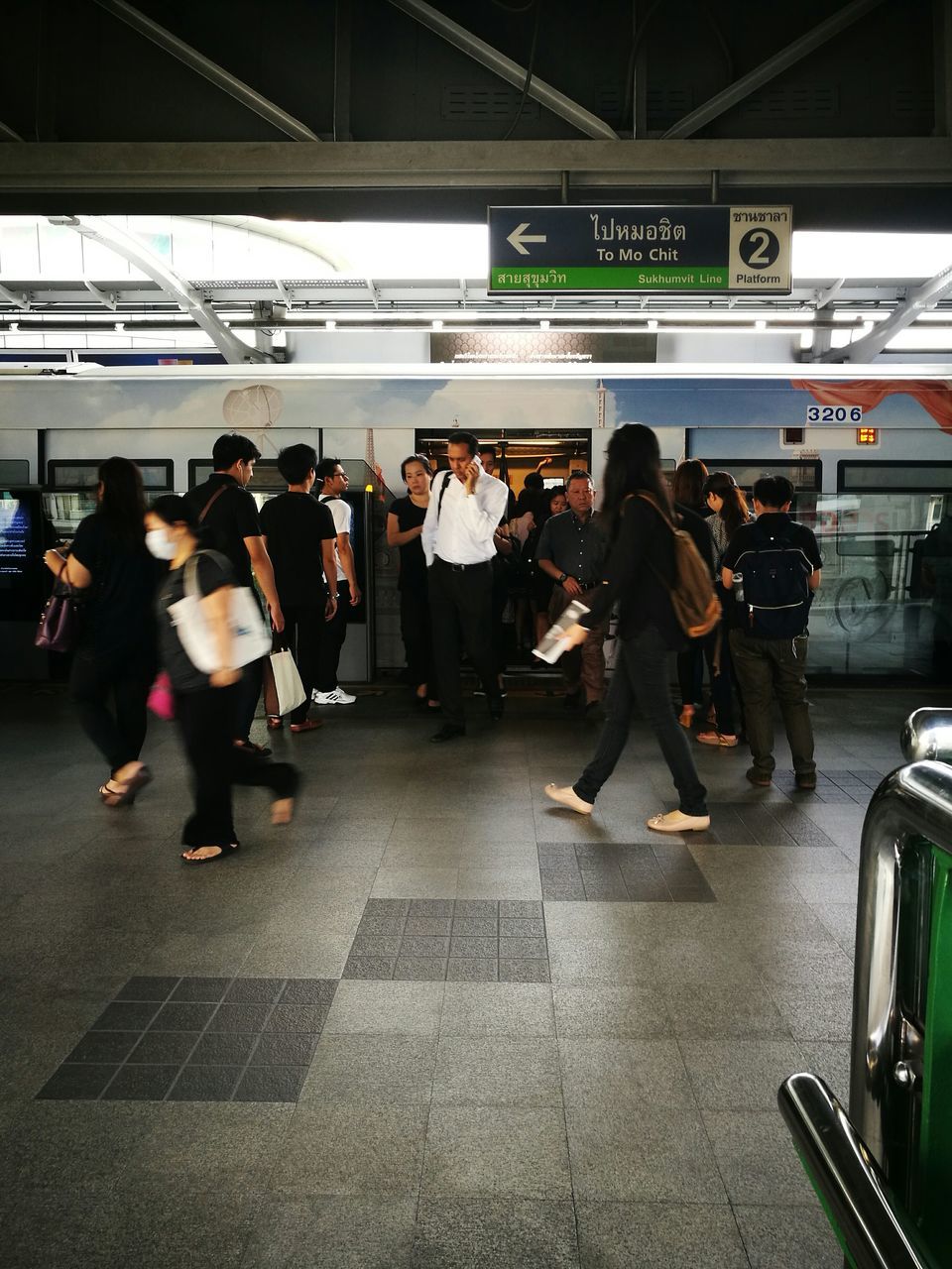 PEOPLE WAITING AT RAILWAY STATION PLATFORM