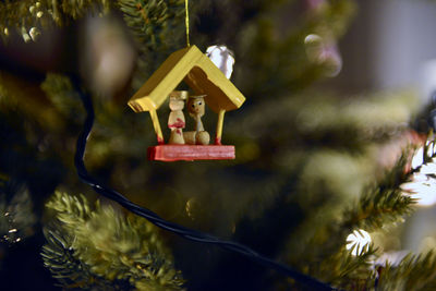 Close-up of christmas decorations hanging on tree