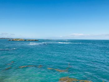 Scenic view of sea against blue sky