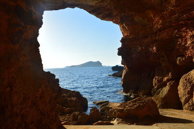 Rock formations by sea against sky