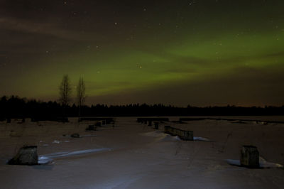 Scenic view of landscape against sky at night during winter