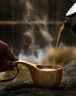 Close-up of hand pouring tea