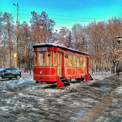 Red truck on snow against sky