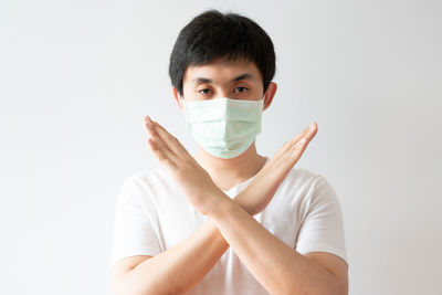 Portrait of young man against white background