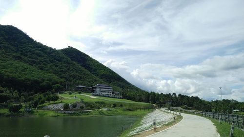 Scenic view of river by landscape against sky