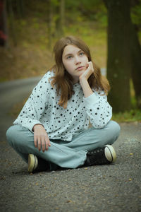 Portrait of young woman sitting outdoors