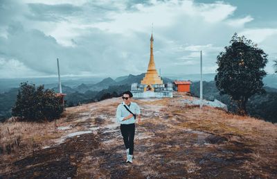 Full length of man on temple against sky