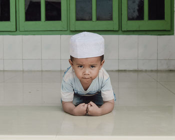 Portrait of boy sitting on table