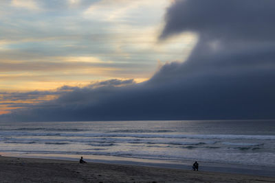 Scenic view of sea against dramatic sky