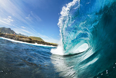 Close-up of sea wave against blue sky