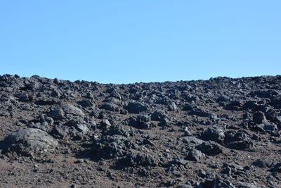 Scenic view of rocky mountains against clear blue sky