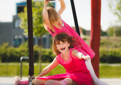 Cheerful friends playing at playground